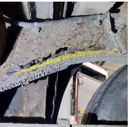 Rusted rear chassis rail on a Nissan Navara before repair