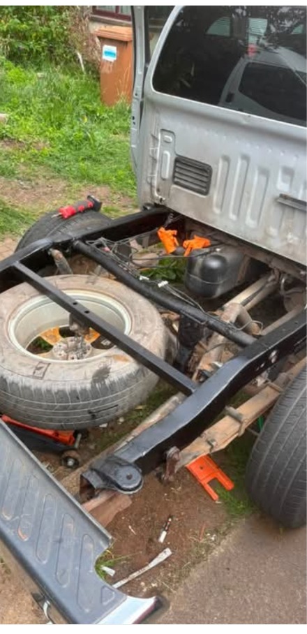 Repaired and painted Navara chassis with the pickup tub lifted off